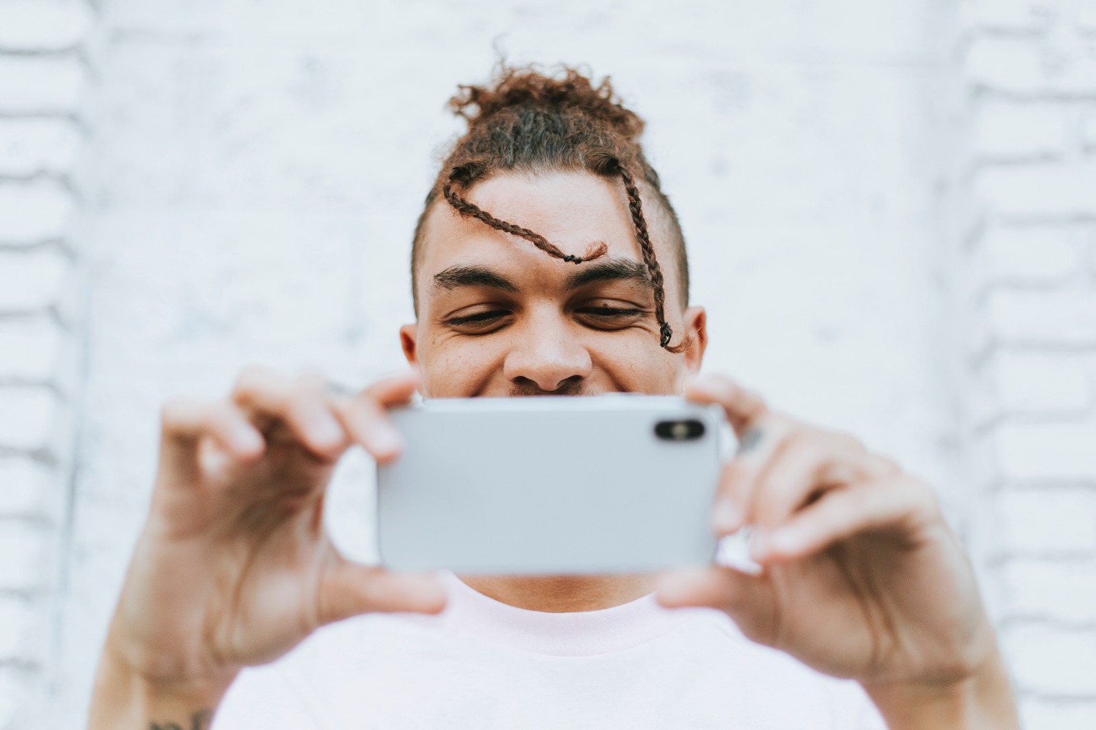 Man with a cell phone positively smiling